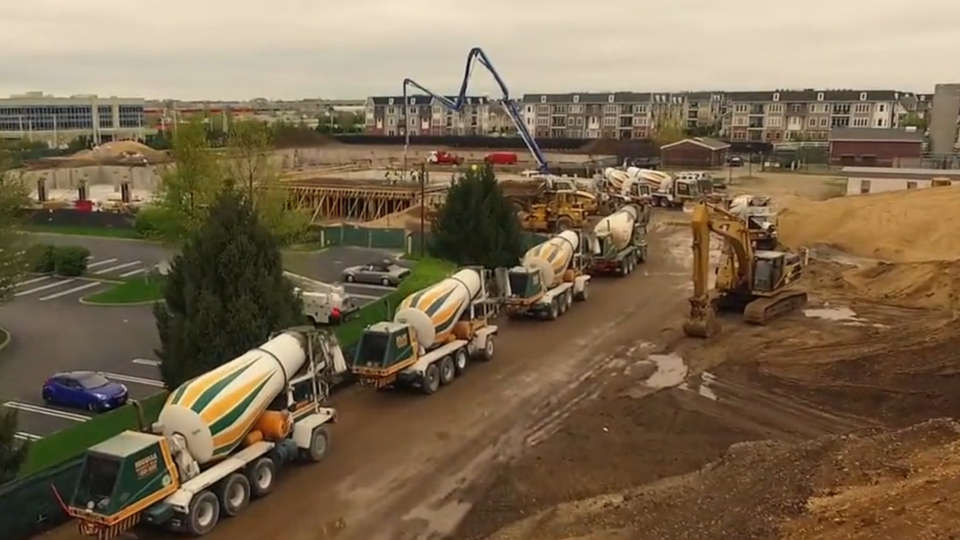 Line of Nicolia mixers staged at a large earthwork site