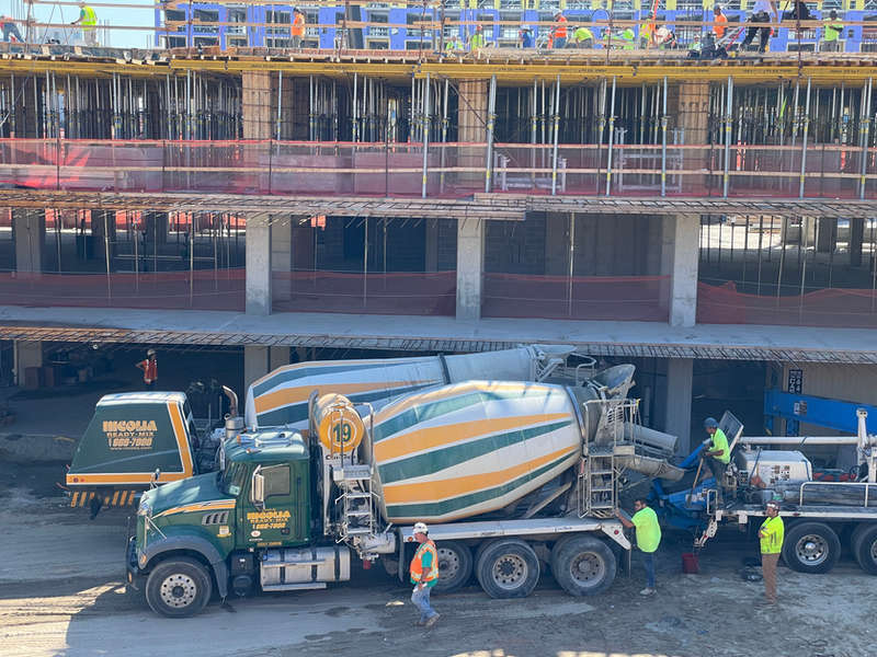 Nicolia mixer on site beside a multi-storey building frame
