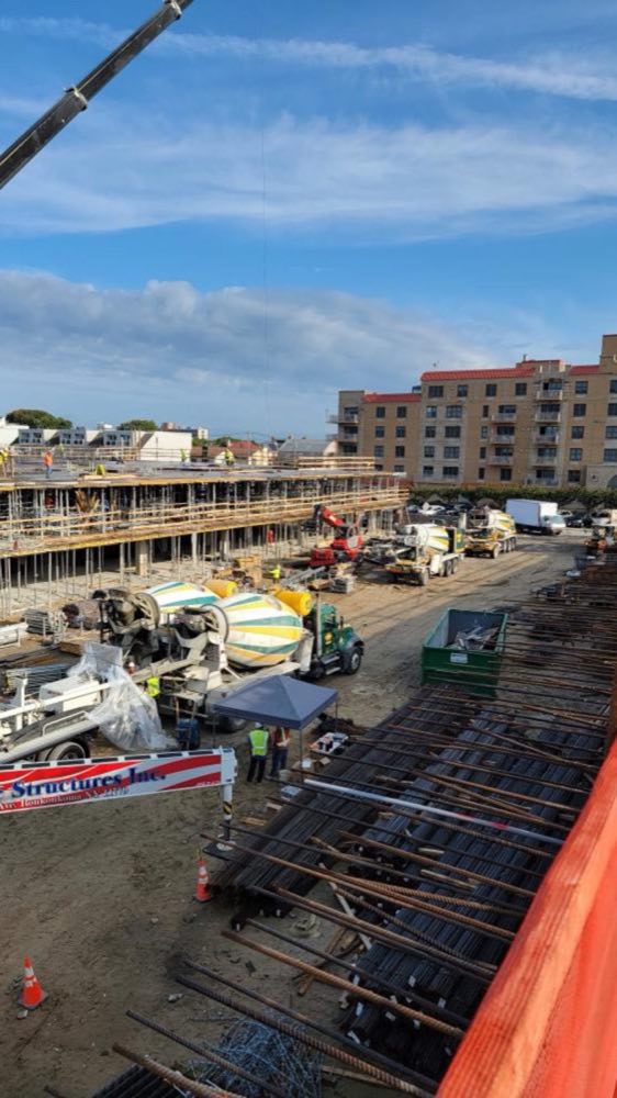 Elevated view of a reinforced deck pour with Nicolia mixers on a multi-family project