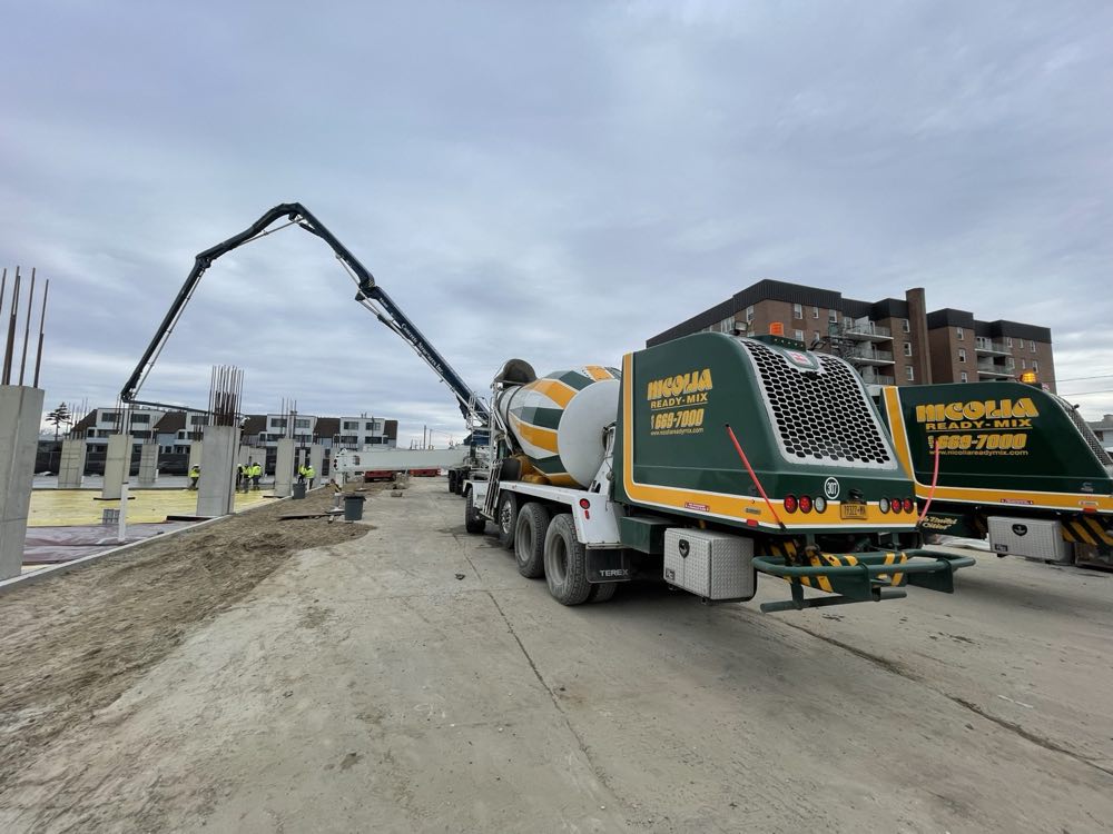 Nicolia mixer truck feeding a concrete pump on site