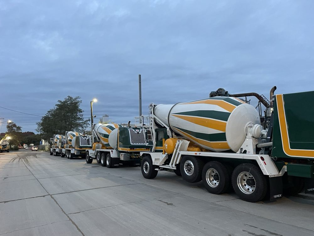 Line of Nicolia mixer trucks staged on the road before a pour