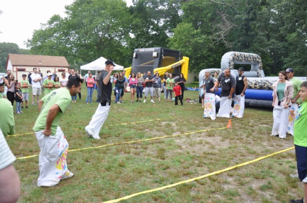 Children and families on the field at the Nicolia family picnic