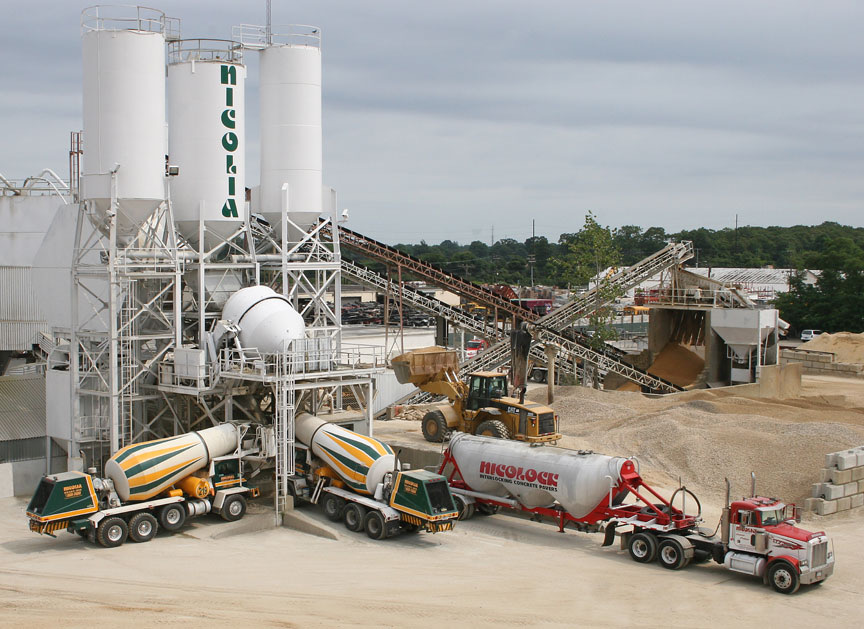 The Nicolia central mix plant at Lindenhurst with silos, aggregate conveyors and front-discharge mixers loading