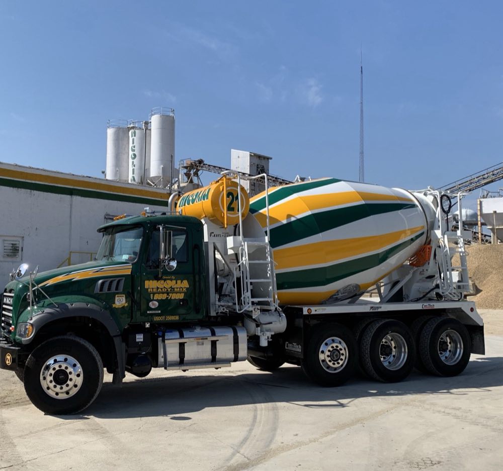 Nicolia Ready-Mix mixer truck parked at the plant beneath the Nicolia cement silos