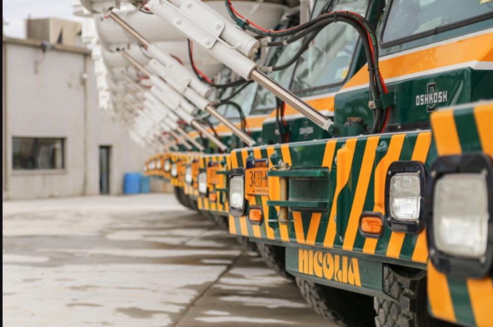 Row of Nicolia front-discharge mixer trucks