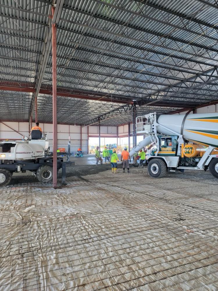 Slab-on-grade pour over wire mesh reinforcement inside a large agricultural building