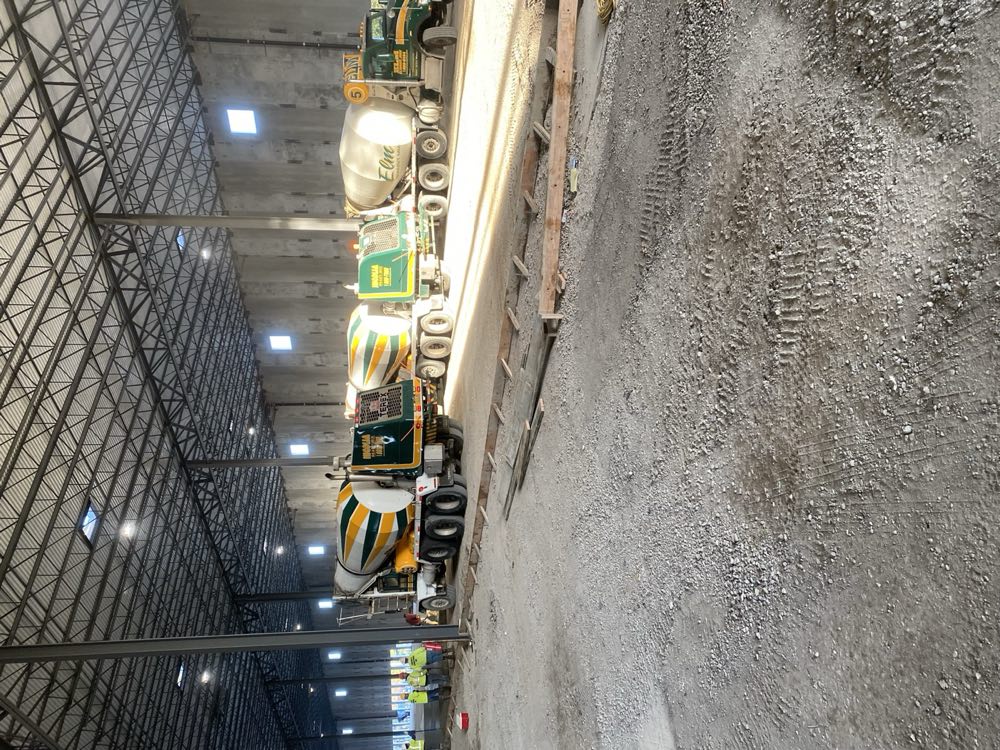 Nicolia mixers lined up inside a warehouse ahead of a floor slab pour