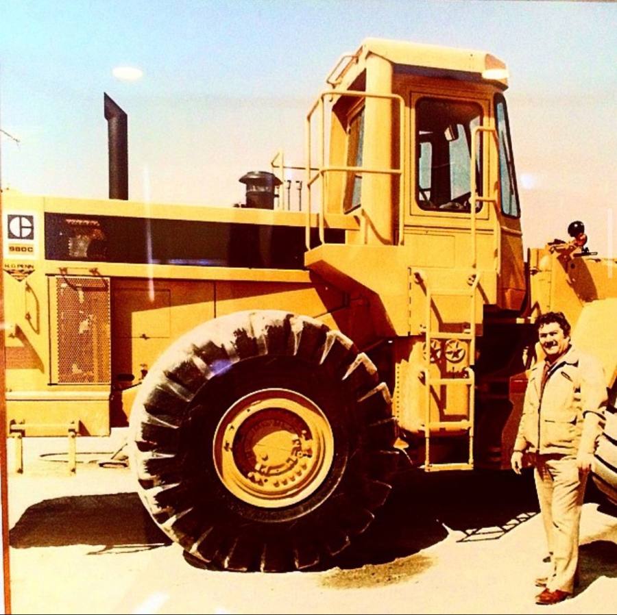 Sante Nicolia standing beside a Caterpillar 980C wheel loader